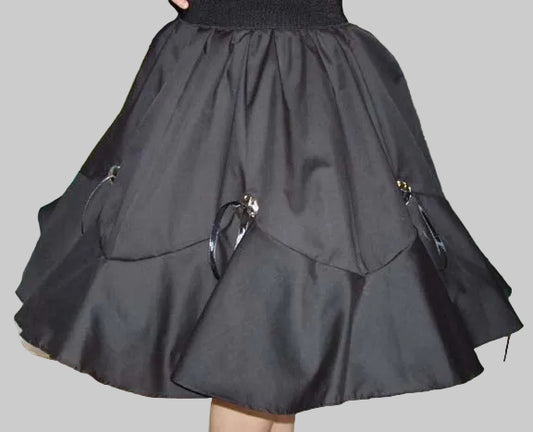 A black gored concho skirt with an elastic waistband, designed for western themed parties or square dance events.